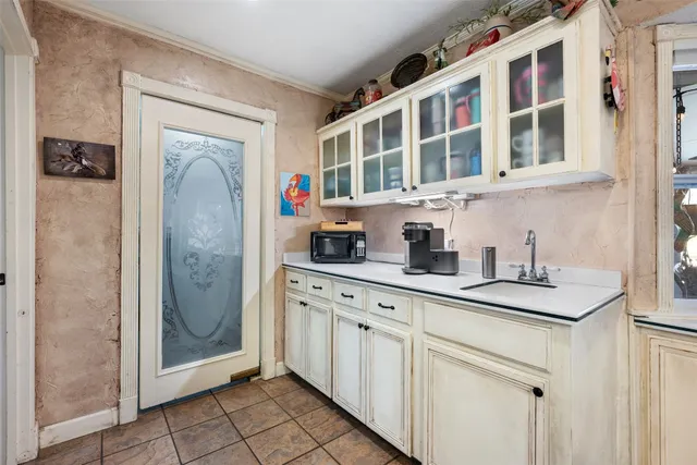 a bathroom with a granite countertop sink a mirror and shower