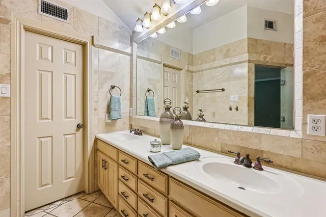 a bathroom with a sink double vanity and a mirror