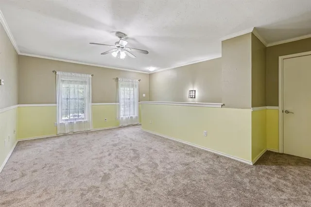 an empty room with closet and windows