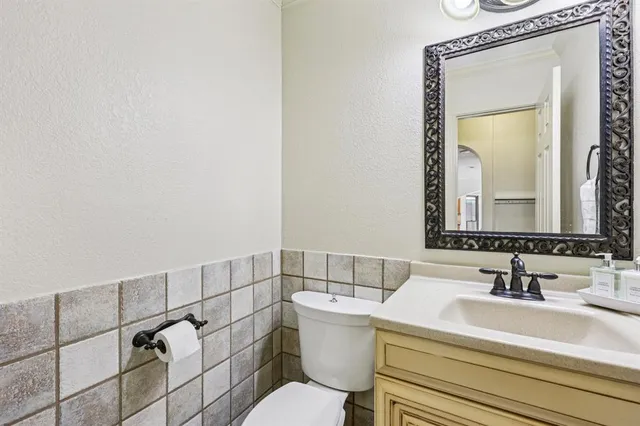 a bathroom with a sink mirror vanity and toilet