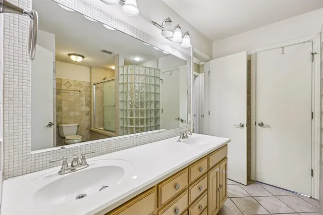 a bathroom with a double vanity sink mirror and double