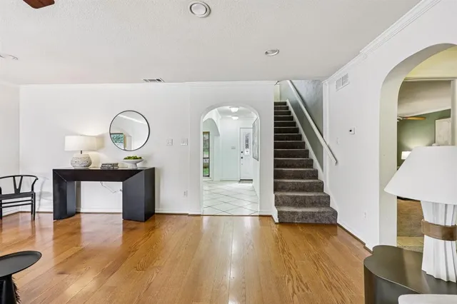 a view of entryway and hall with wooden floor
