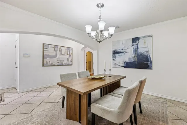 a view of a dining room with furniture a chandelier and wooden floor