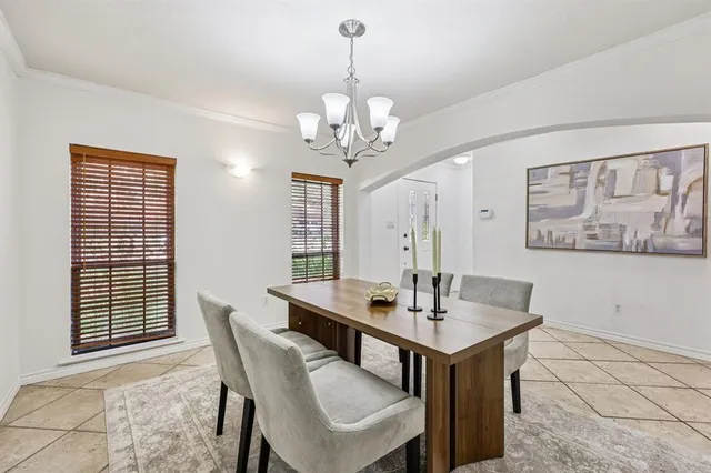 a view of a dining room with furniture and a chandelier