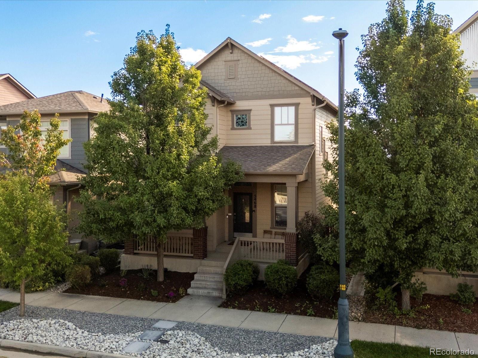 5468 Uinta Way Denver, CO 80238 - Photo 1 of 44 a front view of a house with garden