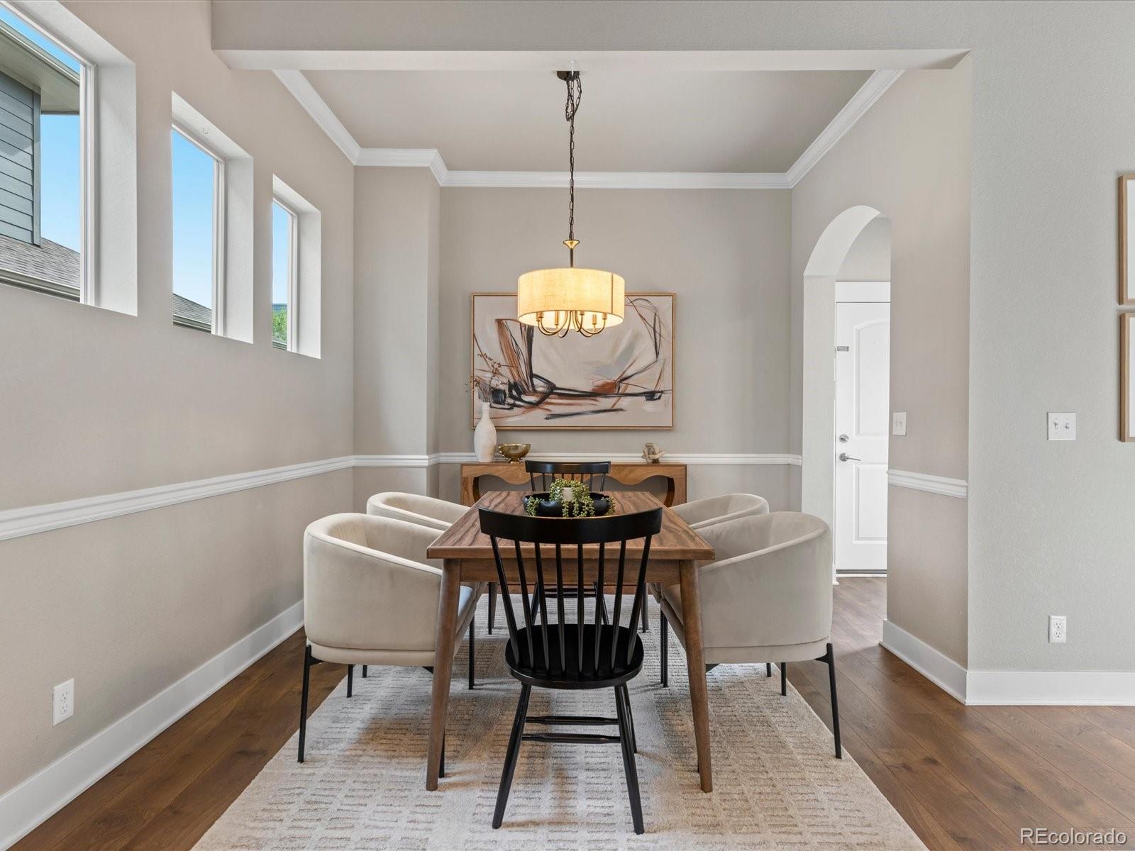 5468 Uinta Way Denver, CO 80238 - Photo 12 of 44 a view of a dining room with furniture window and wooden floor