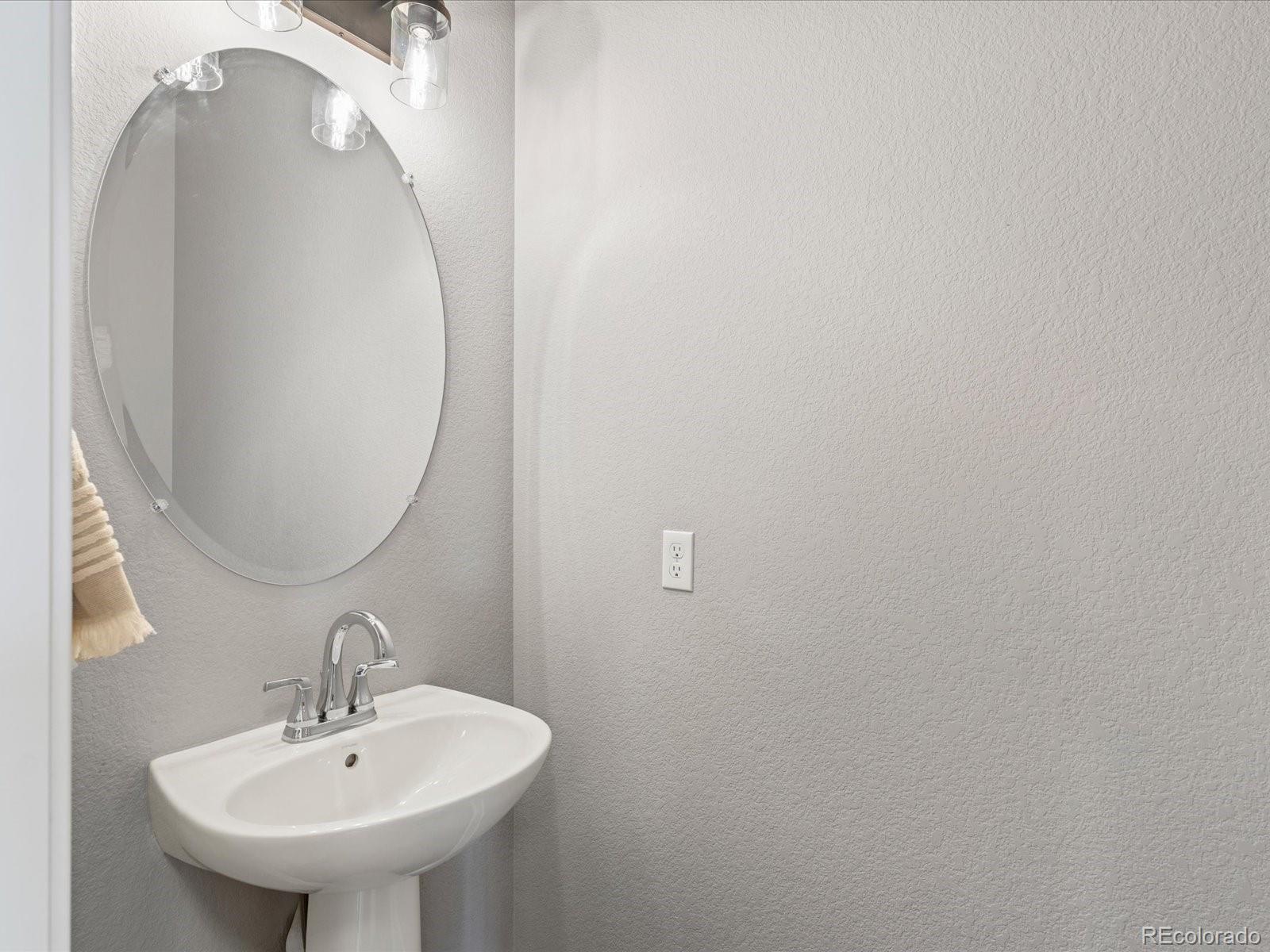 5468 Uinta Way Denver, CO 80238 - Photo 15 of 44 a bathroom with a sink and mirror