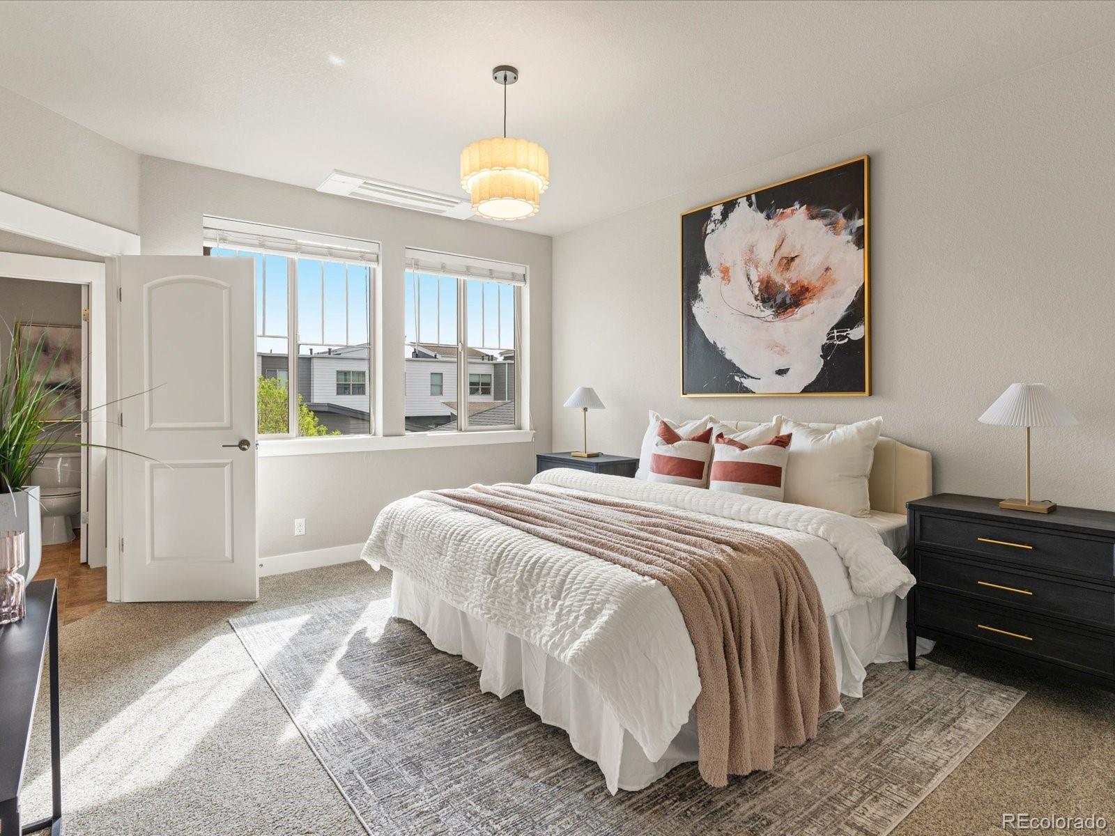 5468 Uinta Way Denver, CO 80238 - Photo 16 of 44 a bedroom with a bed and painting on the wall
