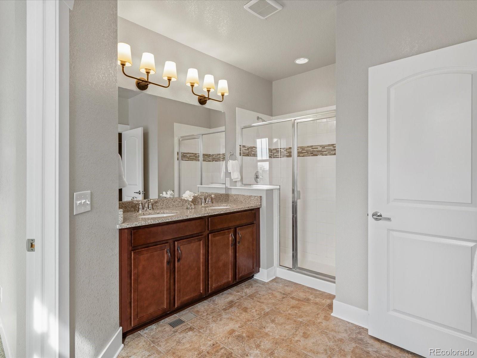 5468 Uinta Way Denver, CO 80238 - Photo 19 of 44 a bathroom with a double vanity sink and a mirror