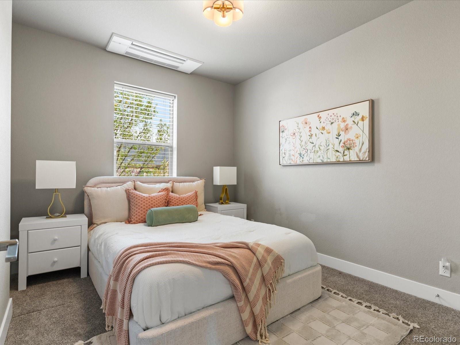 5468 Uinta Way Denver, CO 80238 - Photo 22 of 44 a bedroom with a bed and a painting on the wall