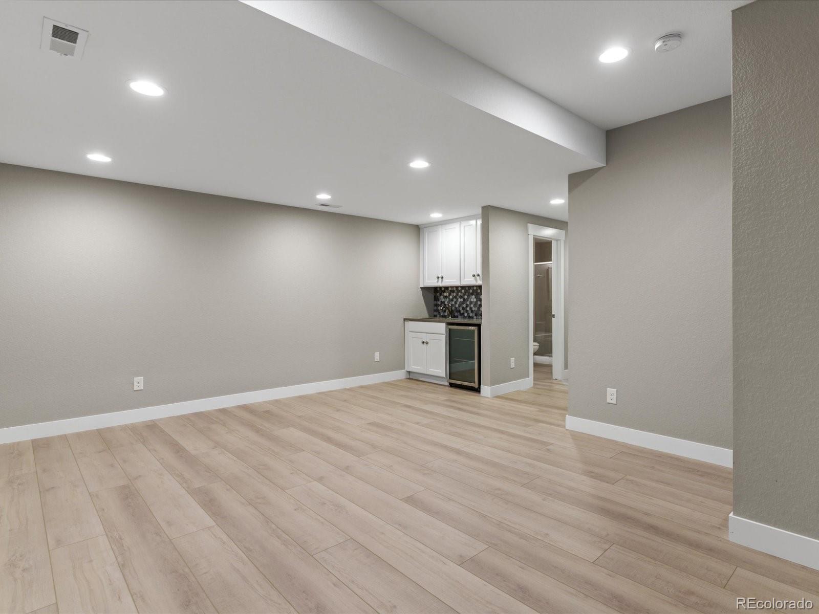 5468 Uinta Way Denver, CO 80238 - Photo 29 of 44 a view of an empty room with a refrigerator