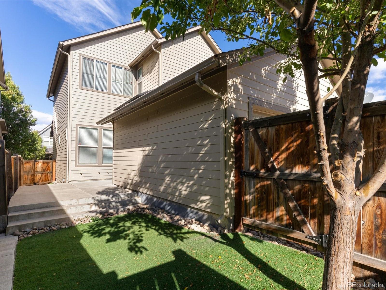 5468 Uinta Way Denver, CO 80238 - Photo 35 of 44 front view of a house with a yard