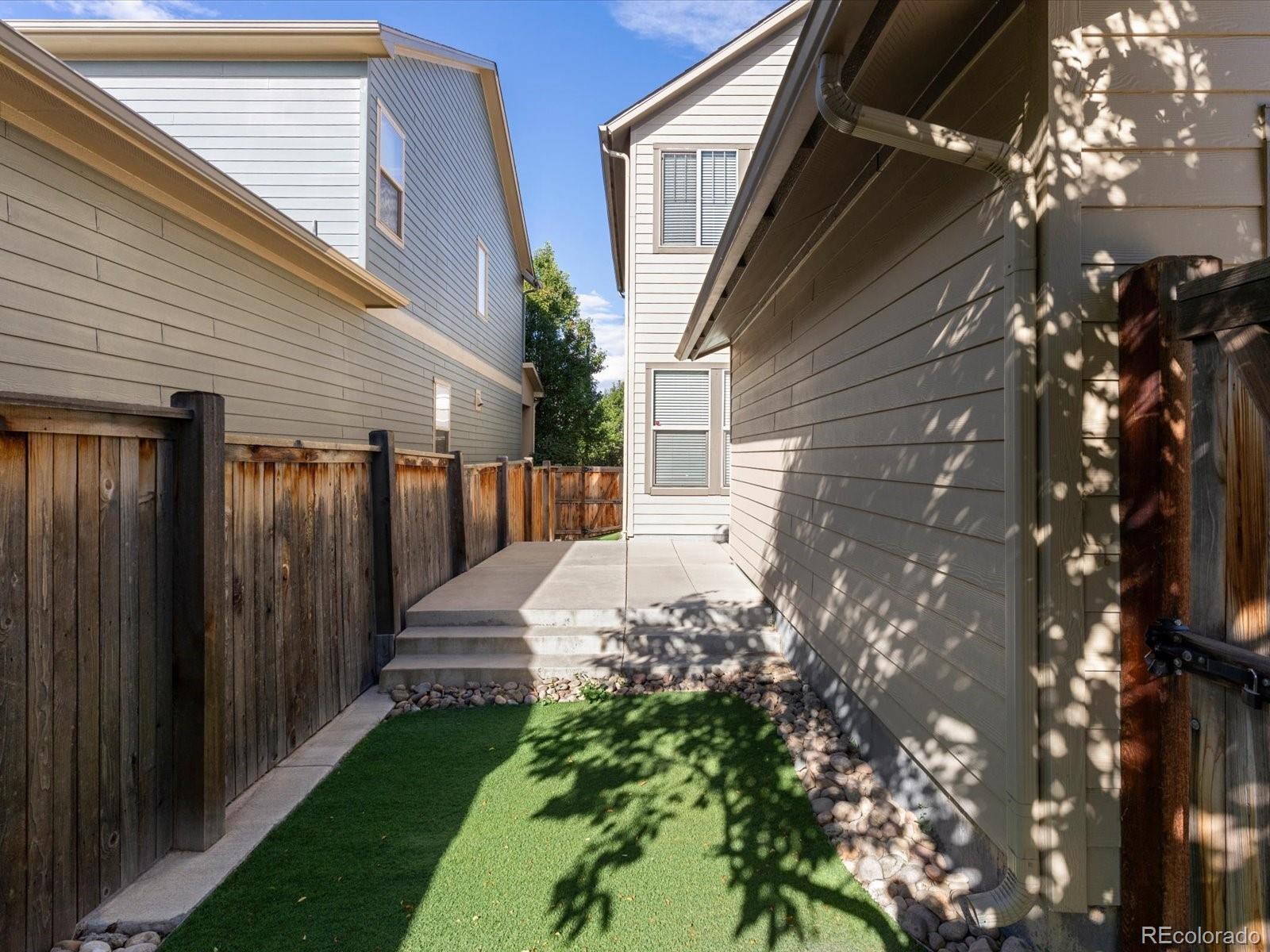 5468 Uinta Way Denver, CO 80238 - Photo 36 of 44 a view of a pathway of a house with a yard