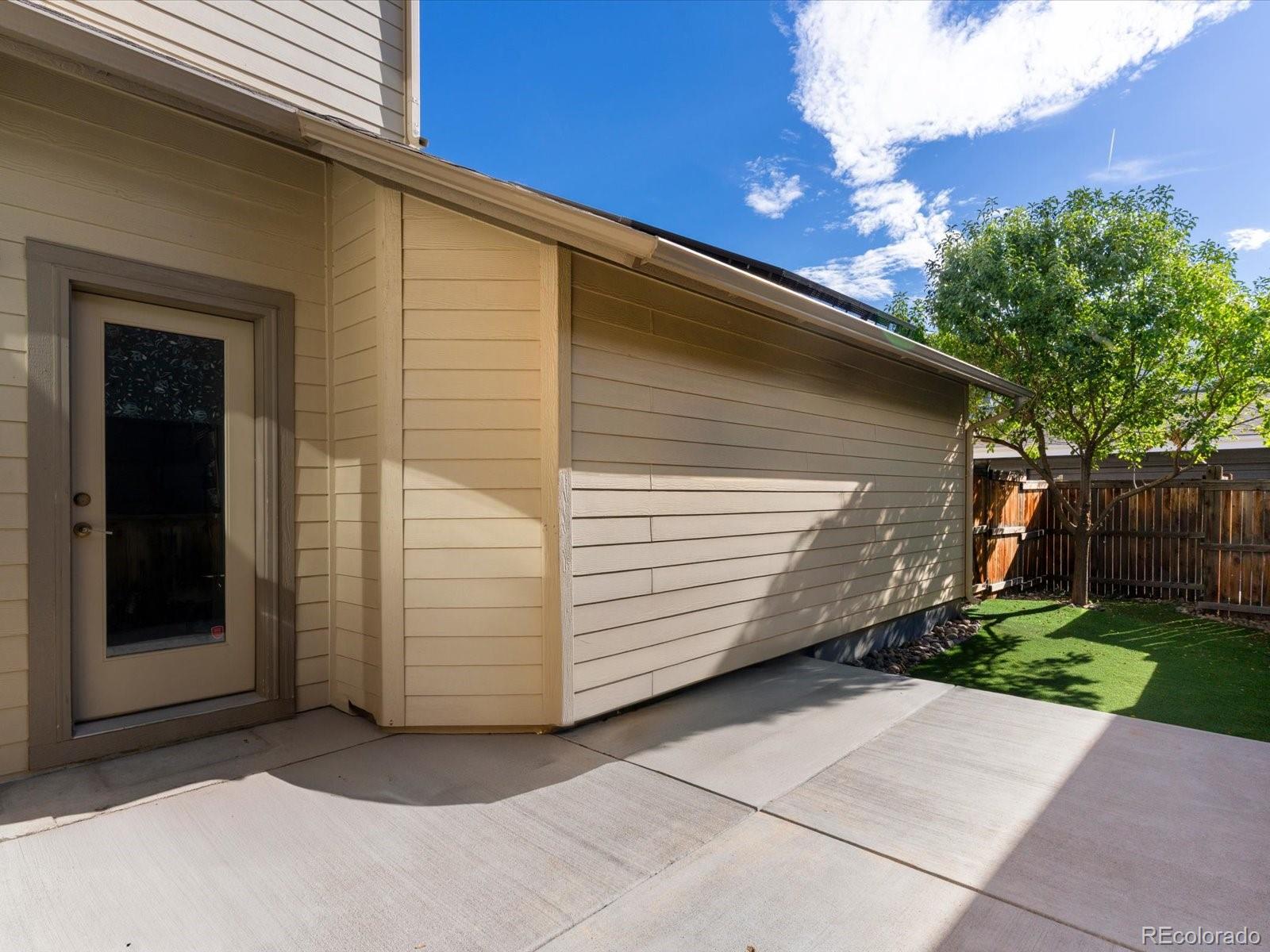 5468 Uinta Way Denver, CO 80238 - Photo 37 of 44 a view of a house with backyard and trees