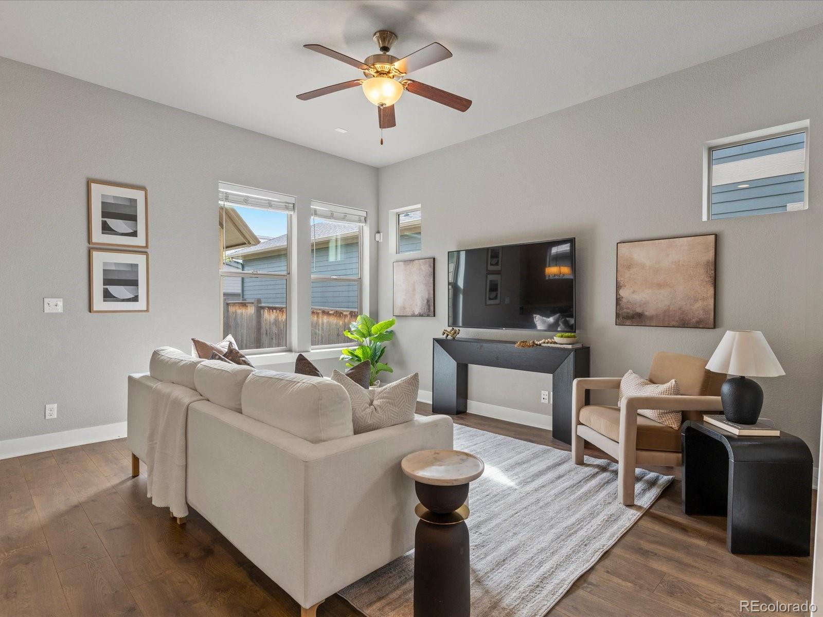 5468 Uinta Way Denver, CO 80238 - Photo 6 of 44 a living room with furniture and a flat screen tv