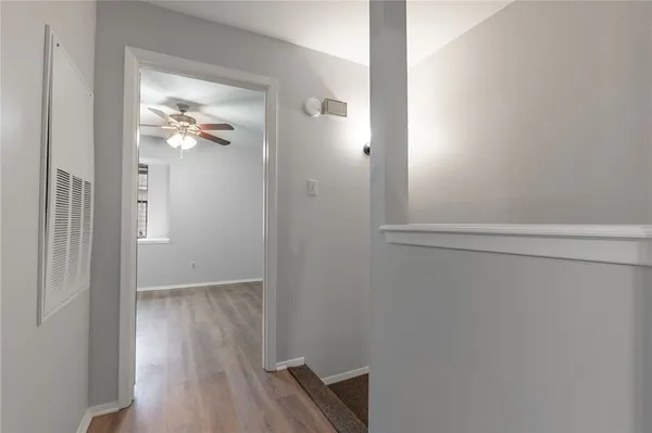 a view of a hallway with wooden floor