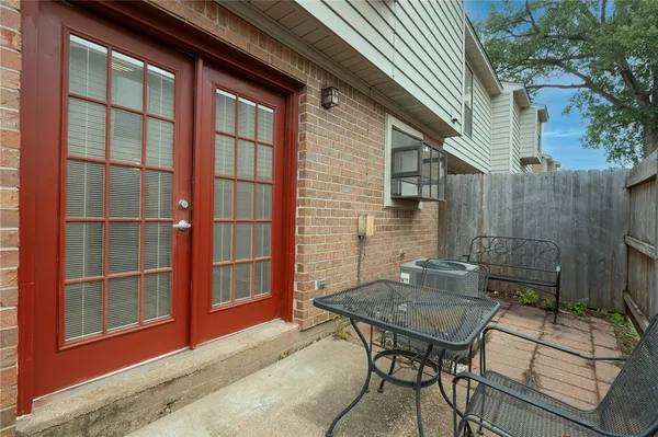 a backyard of a house with table and chairs