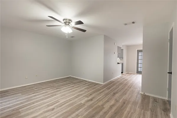 a view of an empty room and wooden floor