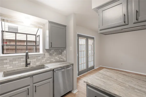a kitchen with a sink and cabinets