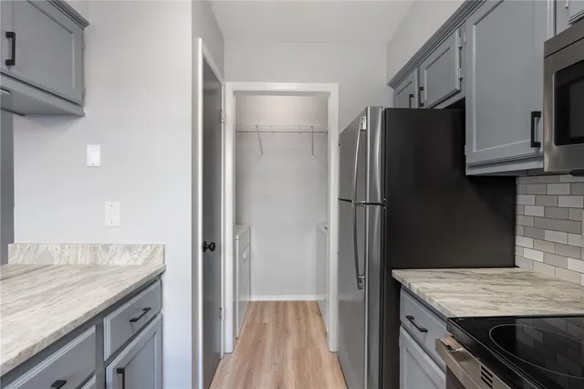 a kitchen with a refrigerator stove and cabinets
