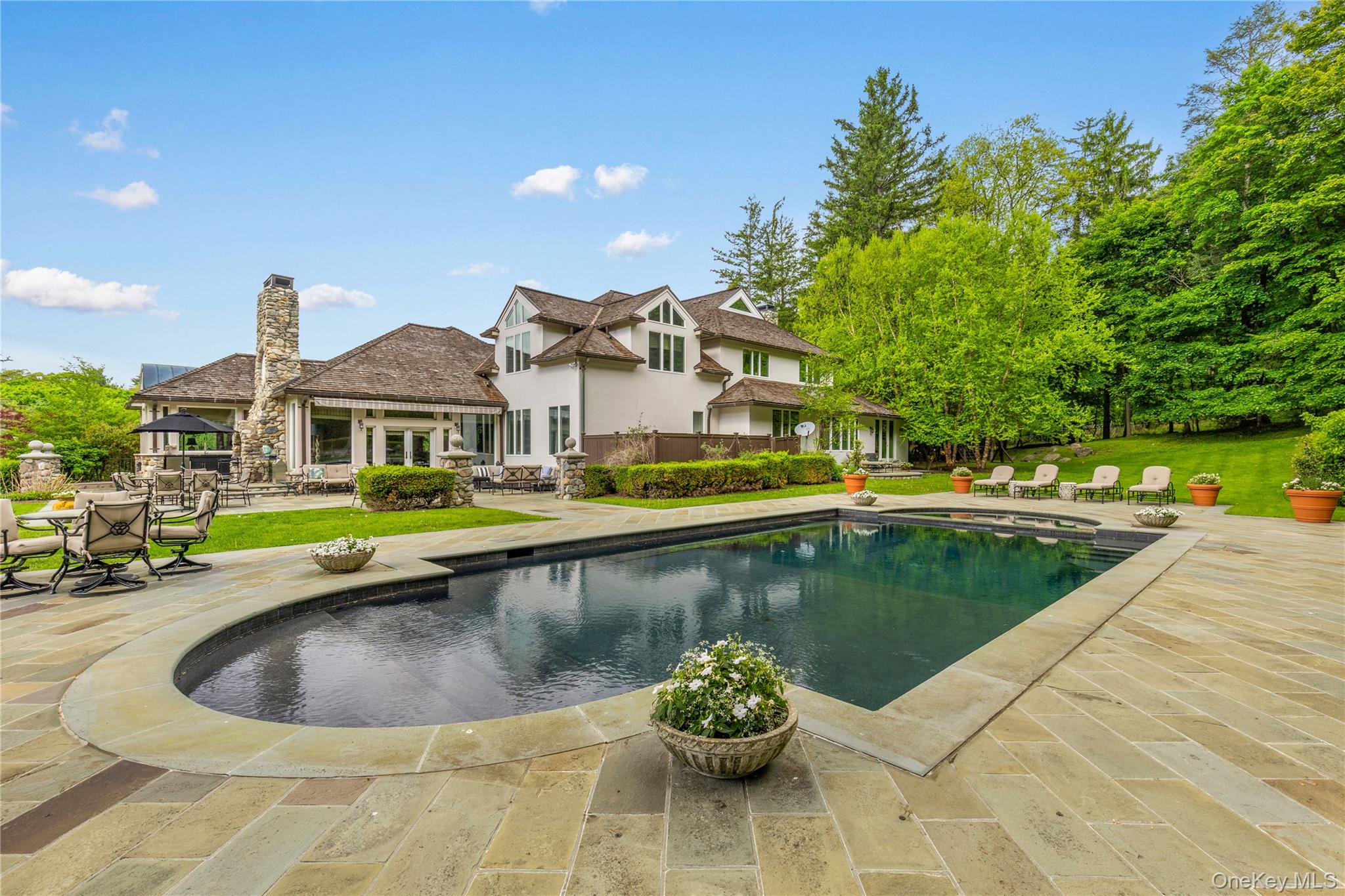 150 Old Farm Road North Chappaqua, NY 10514 - Photo 4 of 44 a view of a swimming pool with a lounge chairs