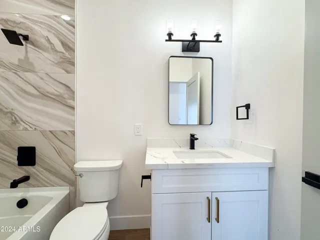 a vase of flowers sitting on a table in front of a window