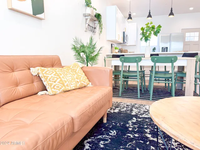 a kitchen with stainless steel appliances granite countertop a stove top oven a sink dishwasher a refrigerator and a refrigerator with wooden floor