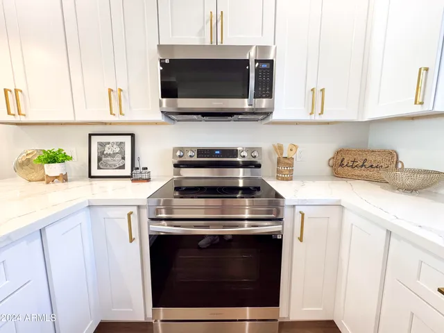 a view of a lush green field with mountains in the background