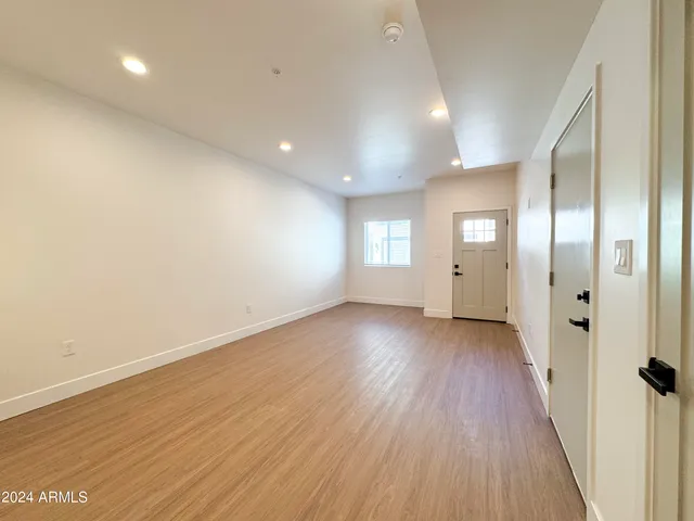 a view of a kitchen with granite countertop a sink and a stove top oven