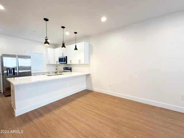 a kitchen with stainless steel appliances a stove sink and refrigerator