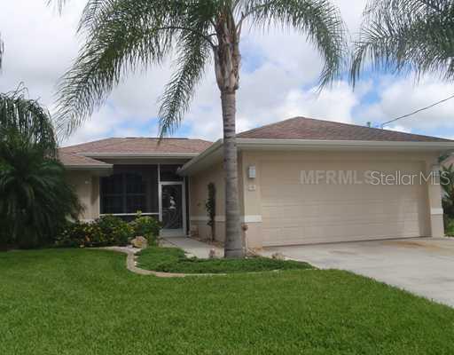 63 Marker Road Rotonda West, FL 33947 - Photo 1 of 1 a front view of house with yard and green space
