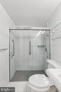 a white toilet sitting next to a bathroom