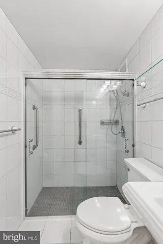 a white toilet sitting next to a bathroom