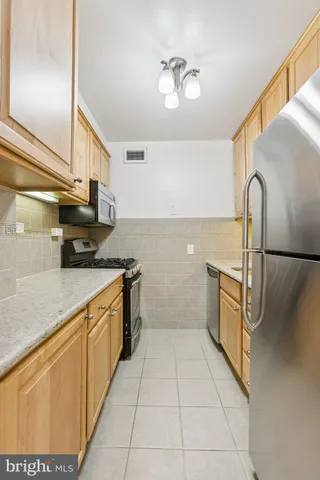 a kitchen with stainless steel appliances granite countertop a sink and cabinets