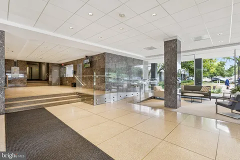 a view of an entryway with a floor to ceiling window and an outdoor kitchen