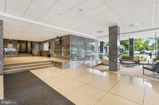 a view of an entryway with a floor to ceiling window and an outdoor kitchen
