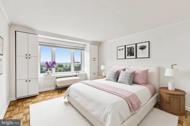 a bedroom with a large bed and a chandelier