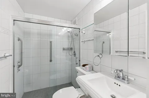 a bathroom with a sink toilet and shower