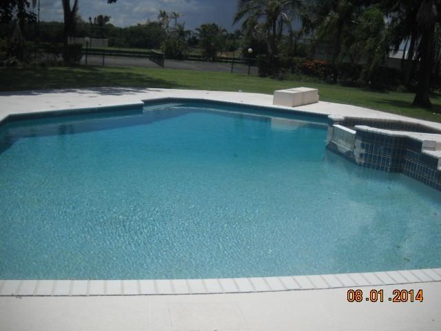 8601 Surrey Lane Boca Raton, FL 33496 - Photo 16 of 18 a view of swimming pool with a yard and green space