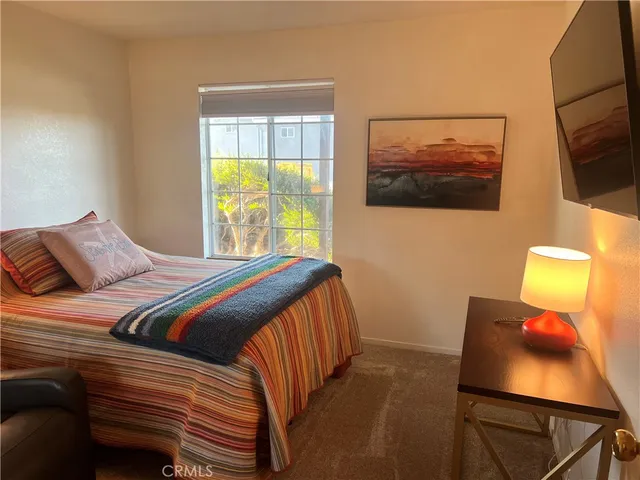a bedroom with a bed and flat screen tv
