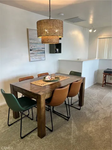 a dining room with a table chairs and a wooden floor