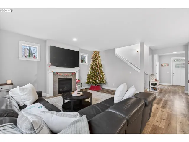 a living room with furniture a flat screen tv and a fireplace