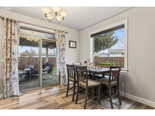 a view of a dining room with furniture wooden floor and a chandelier
