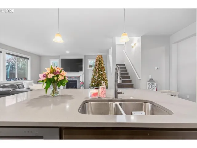 a kitchen with kitchen island a sink and a chandelier