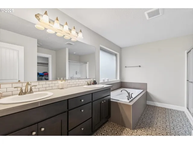 a bathroom with a sink a light fixture and a mirror