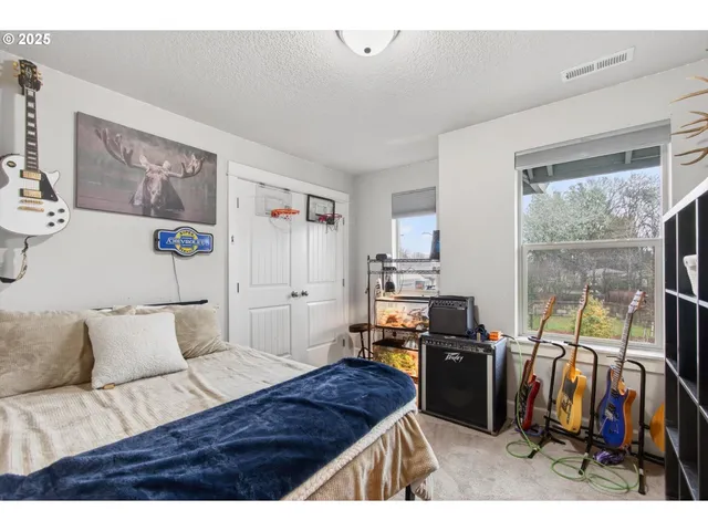 a bedroom with furniture and a flat screen tv
