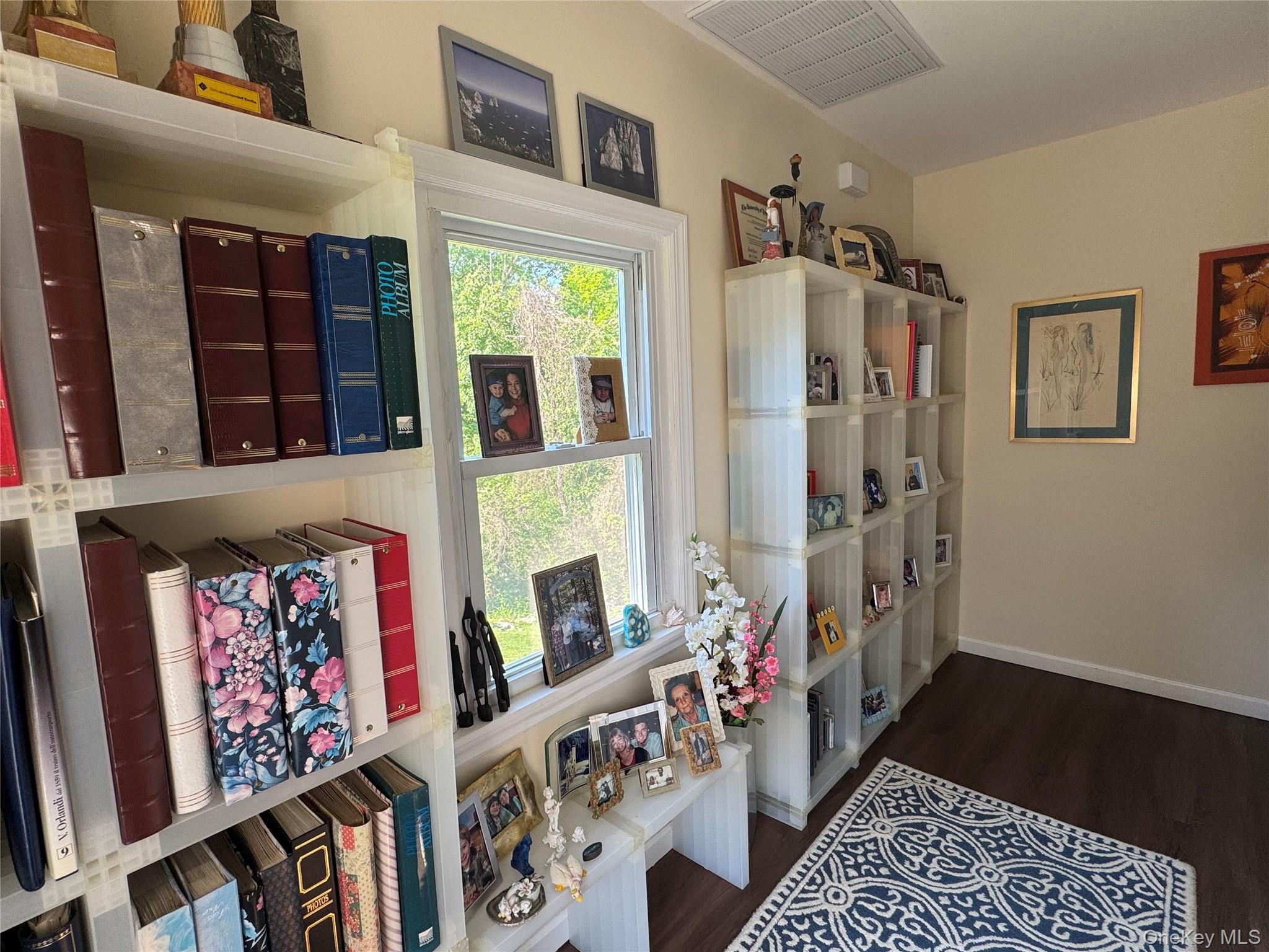 62 Whippoorwill Road East, Unit A Armonk, NY 10504 - Photo 7 of 15 Upper floor landing with shelving, large window and Laundry closet