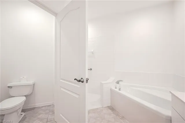 a bathroom with a bathtub and toilet