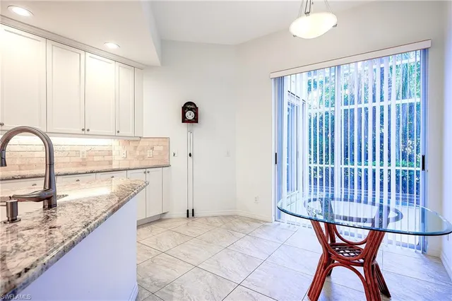 a view of a kitchen with granite countertop a table and chairs