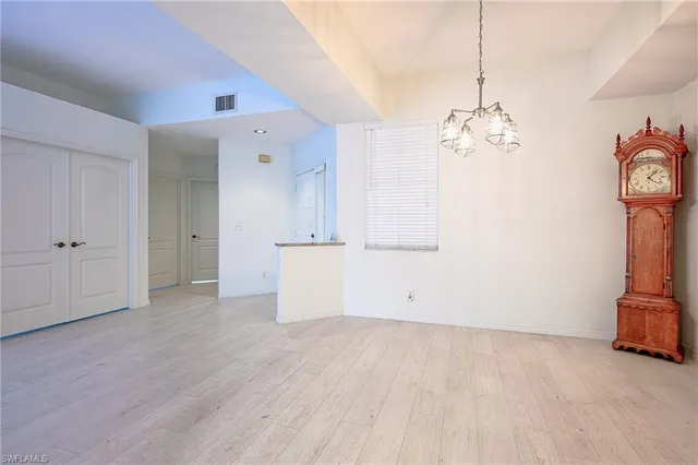 a view of a room with wooden floor and a ceiling fan